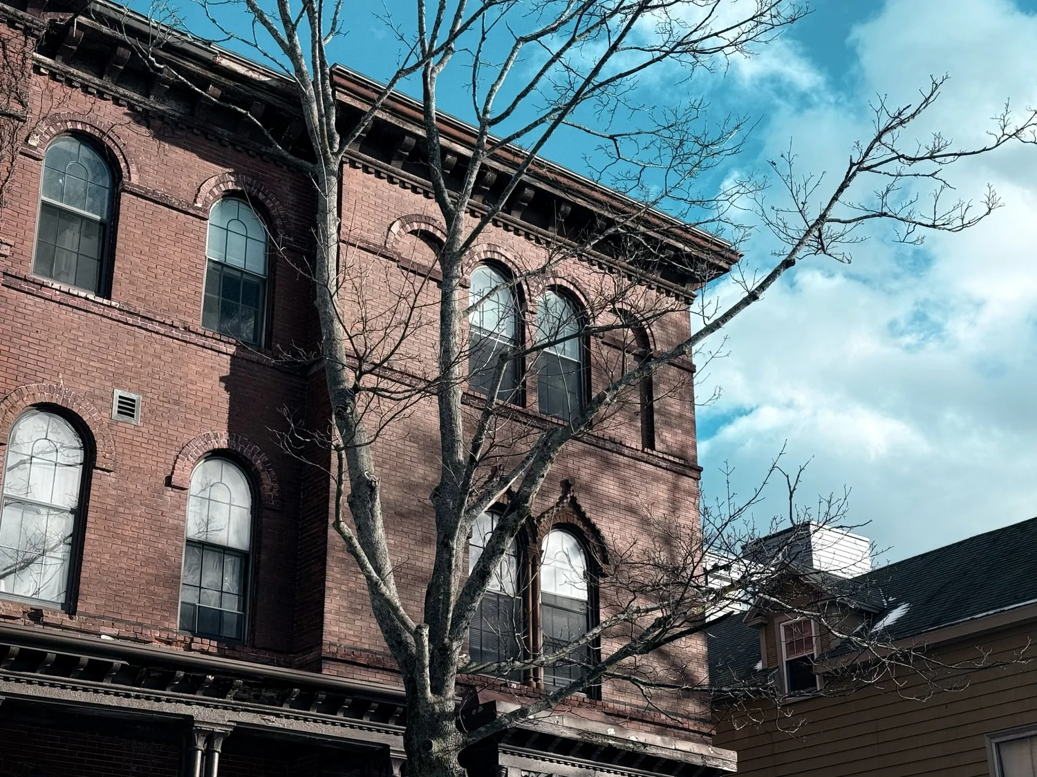 Brick row house with arched windows in Portland's Munjoy Hill